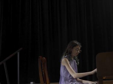 Middle school aged girl playing the piano