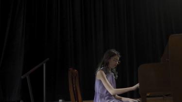 Middle school aged girl playing the piano