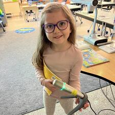Young female student holding a microphone